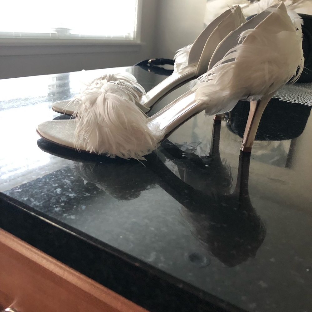 Peep-toe pump with feather detailing.